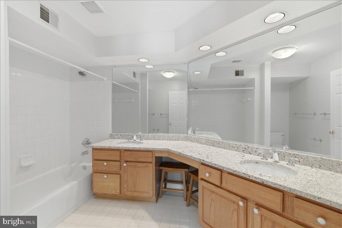 1304 F Garden Wall Circle Reston, VA 20194 - Photo 15 of 23 a bathroom with a granite countertop sink and a mirror