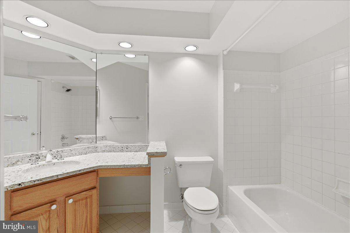 1304 F Garden Wall Circle Reston, VA 20194 - Photo 17 of 23 a bathroom with a granite countertop sink toilet and shower