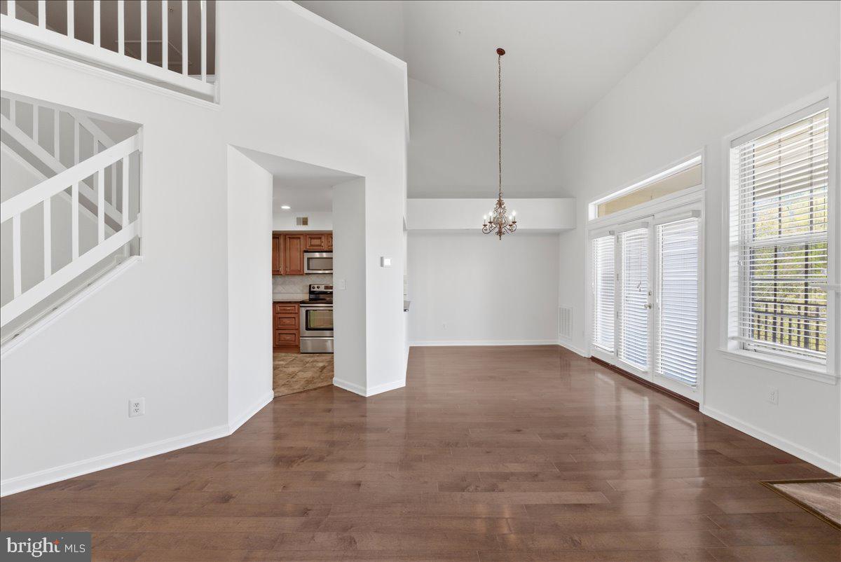1304 F Garden Wall Circle Reston, VA 20194 - Photo 4 of 23 an empty room with windows and entrance