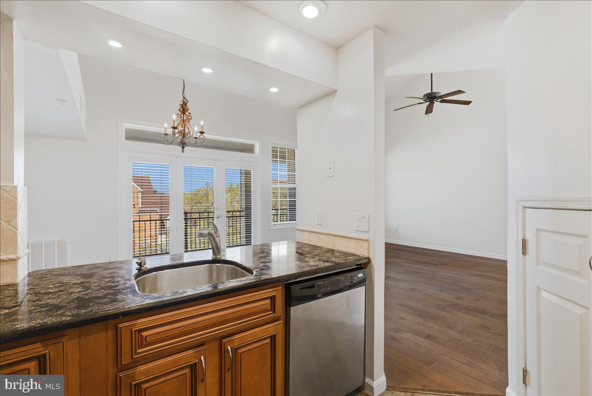 1304 F Garden Wall Circle Reston, VA 20194 - Photo 9 of 23 a kitchen with granite countertop a sink and a granite counter tops