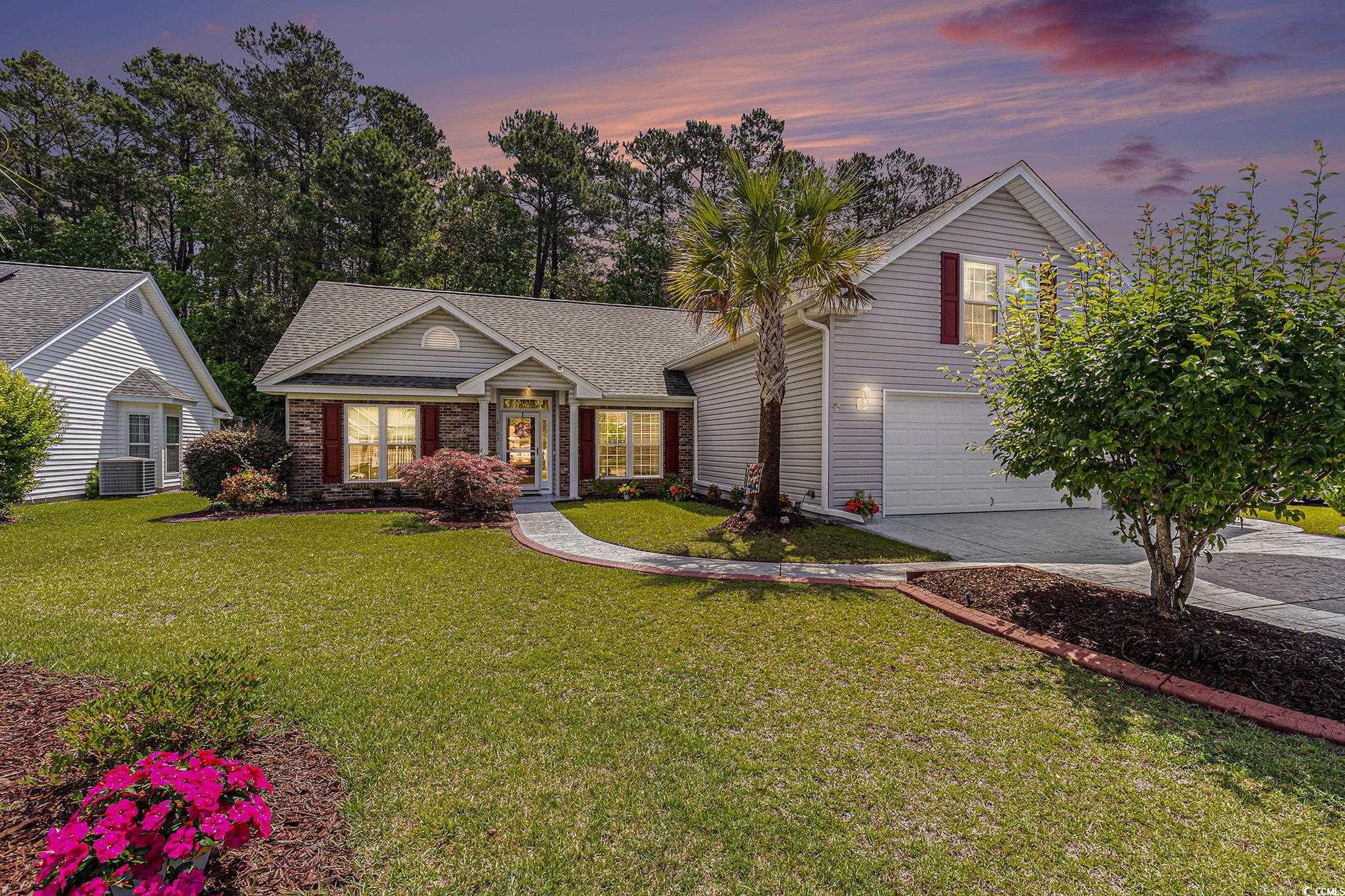 1105 Lampwick Lane Murrells Inlet, SC 29576 - Photo 2 of 40 View of front of property featuring driveway, a garage, a front lawn, and cooling unit