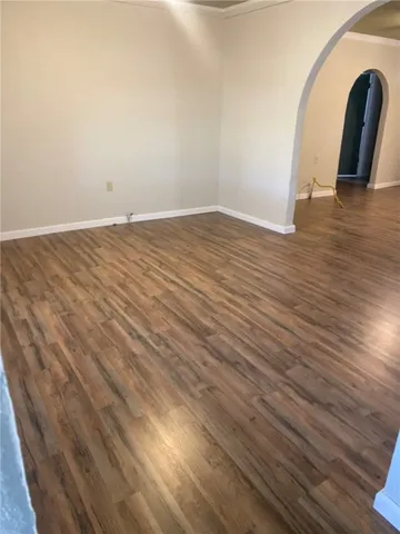 a view of a room with wooden floor