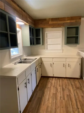 a spacious bathroom with a sink a large mirror and bathtub