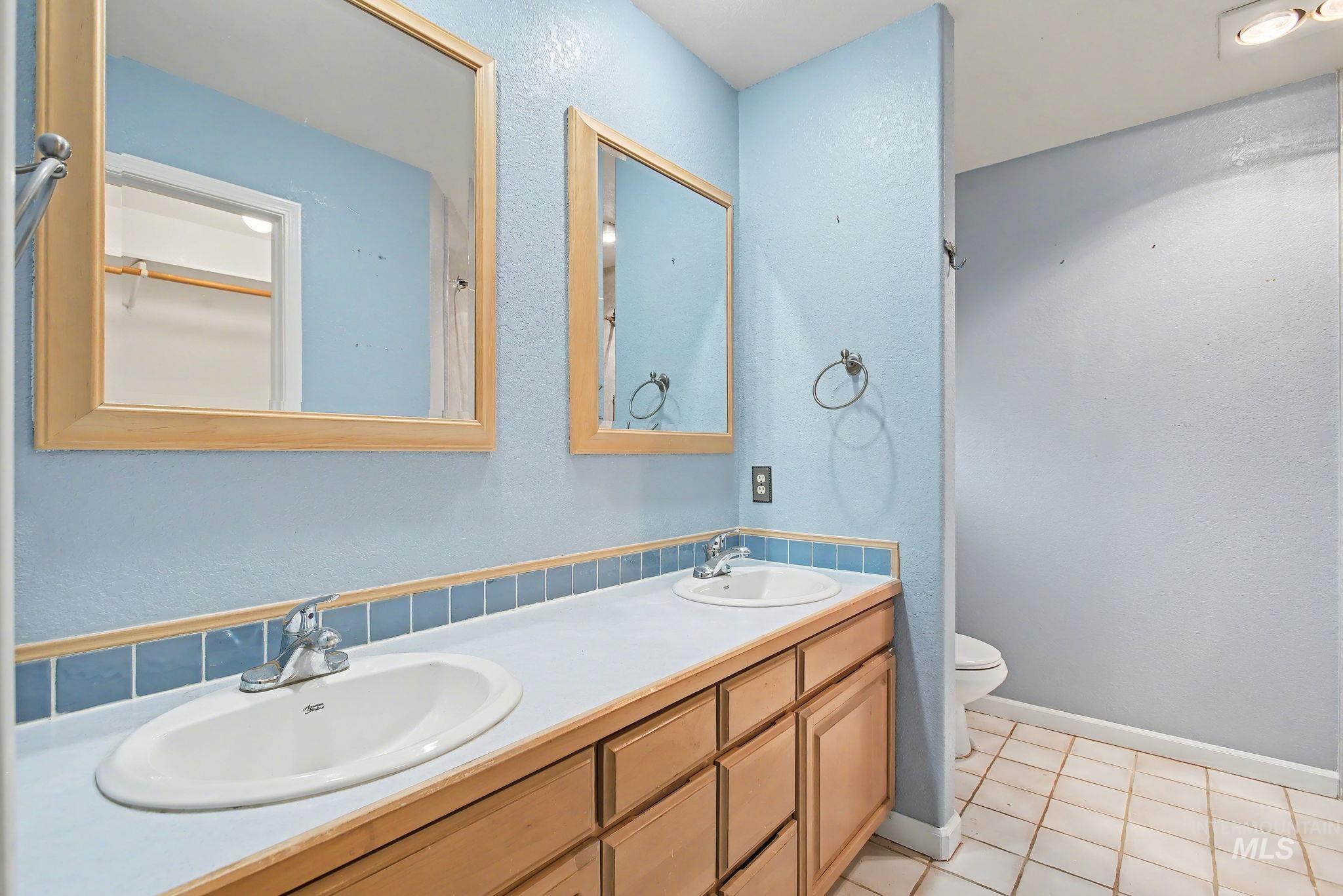2242 Chukar Lane Clarkston, WA 99403 - Photo 22 of 41 Bathroom with a textured wall, double vanity, and light tile patterned flooring