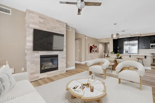 a large white bed in a white room with kitchen island