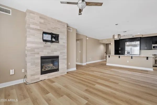 a living room with furniture a fireplace and a flat screen tv