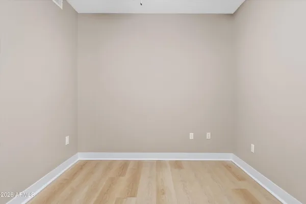 a view of a workspace with furniture and wooden floor