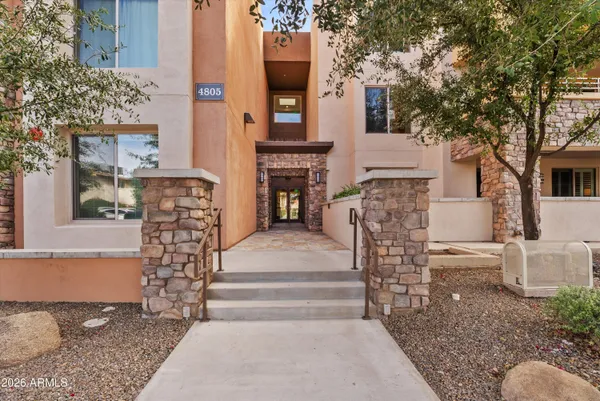 a front view of a house with large windows