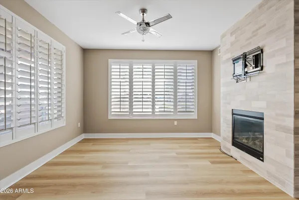 a large white kitchen with kitchen island a sink stainless steel appliances and cabinets