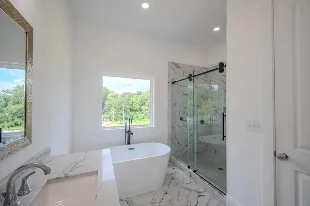 a bathroom with a bathtub and a sink
