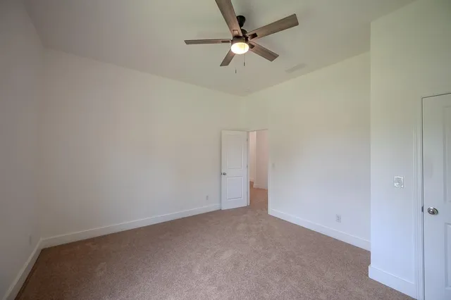 an empty room with a ceiling fan and a ceiling fan