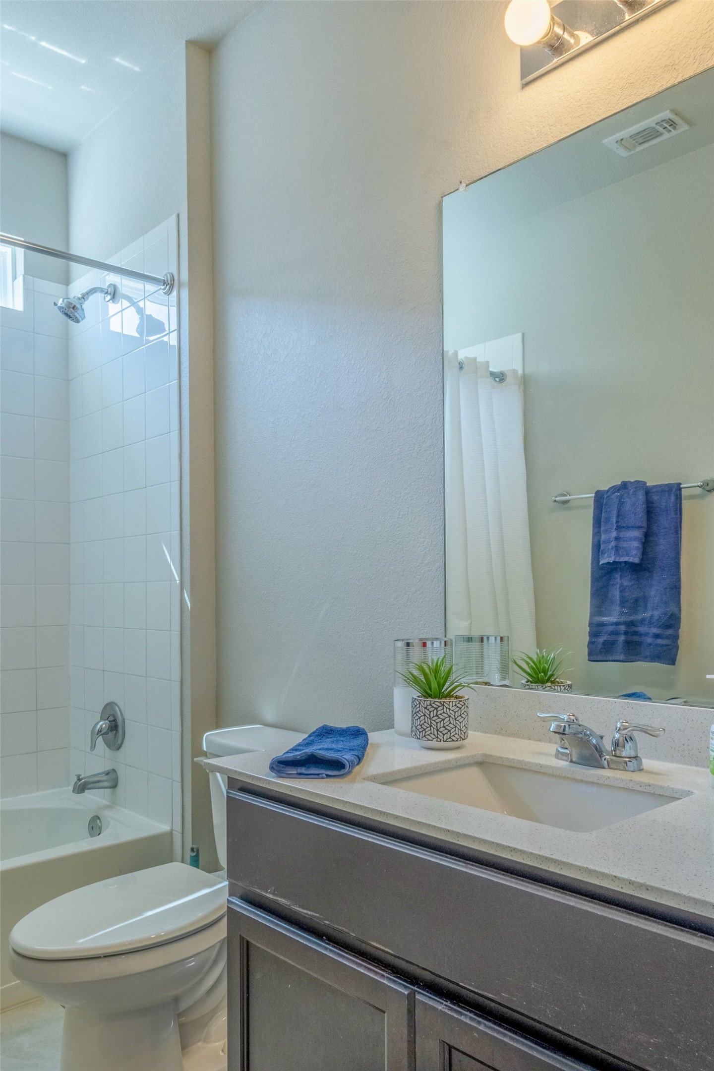 7225 Ranchito Drive Austin, TX 78744 - Photo 17 of 39 A pristine bathroom featuring a sleek vanity and a combination shower-tub.