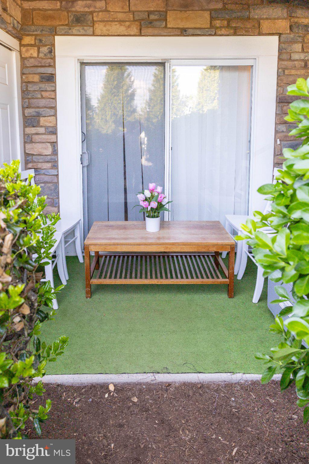12824 Clarksburg Square Road, Unit 105 Clarksburg, MD 20871 - Photo 92 of 96 Charming patio retreat with greenery.