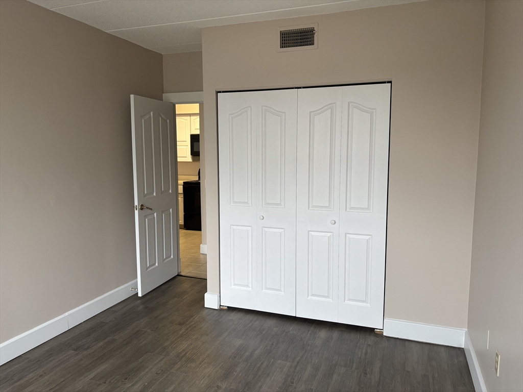 34 Sumner Avenue, Unit 411 Springfield, MA 01108 - Photo 6 of 8 a view of an empty room with wooden floor