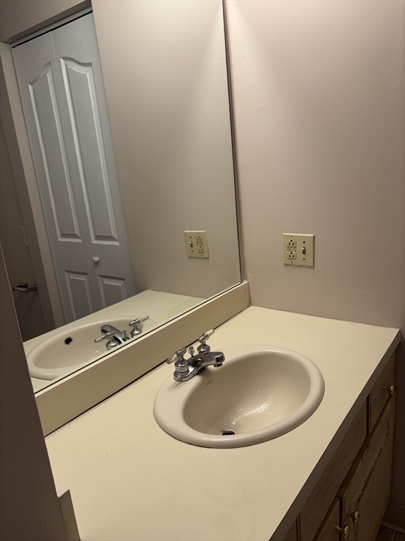 34 Sumner Avenue, Unit 411 Springfield, MA 01108 - Photo 7 of 8 a bathroom with a sink and a mirror