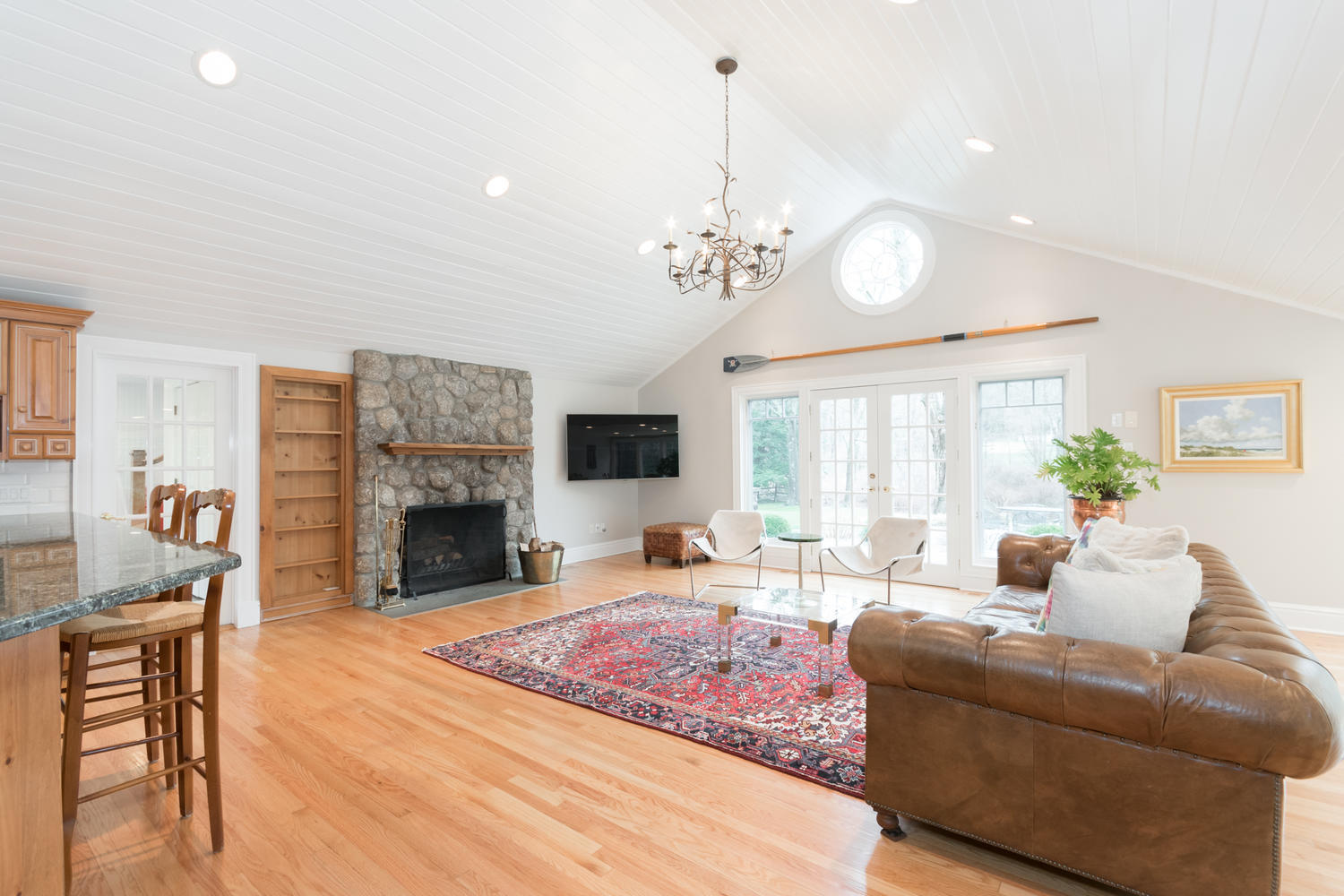 783 Valley Road New Canaan, CT 06840 - Photo 11 of 23 a living room with fireplace furniture and a chandelier