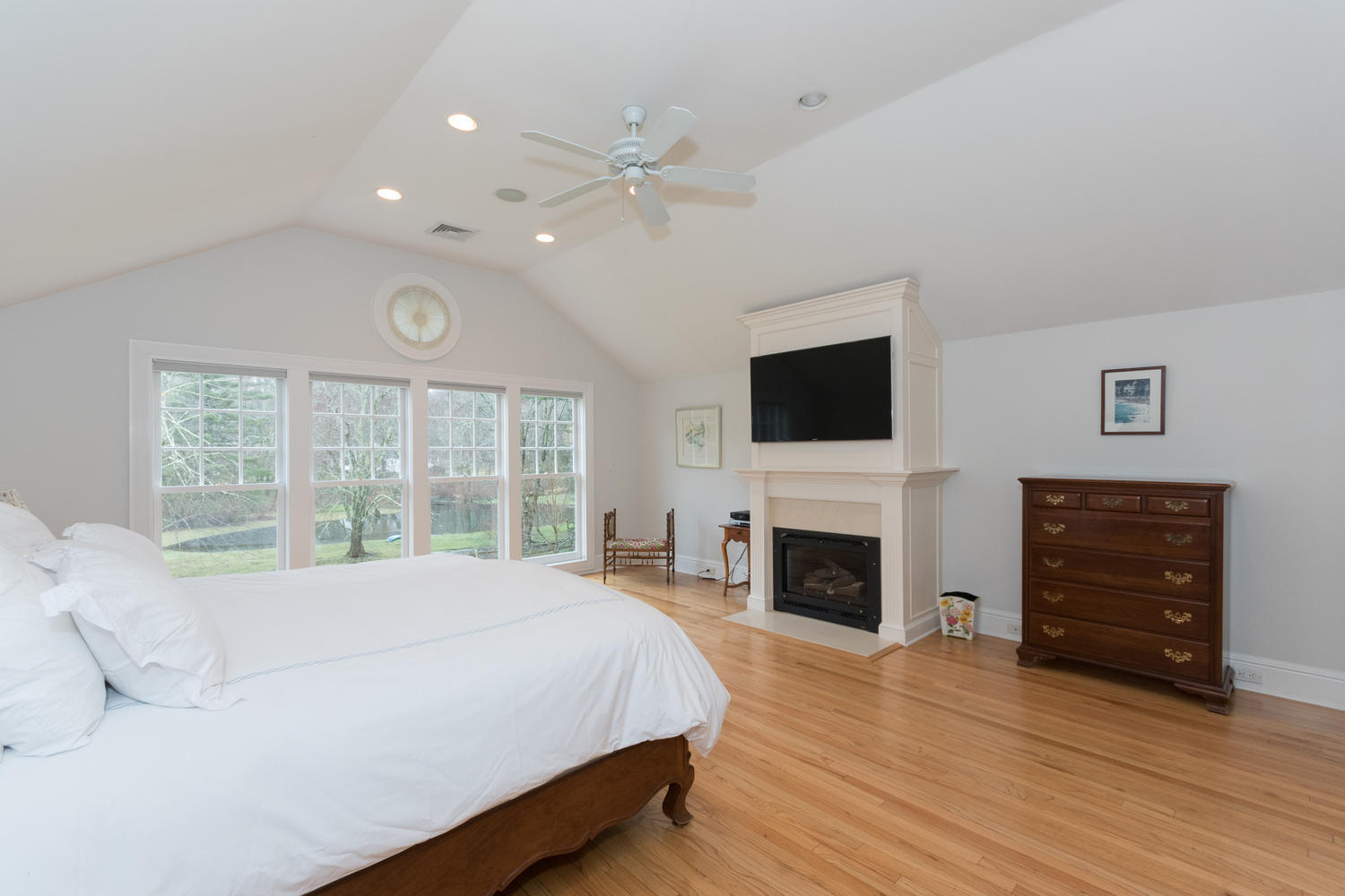 783 Valley Road New Canaan, CT 06840 - Photo 15 of 23 a spacious bedroom with a bed and a flat screen tv