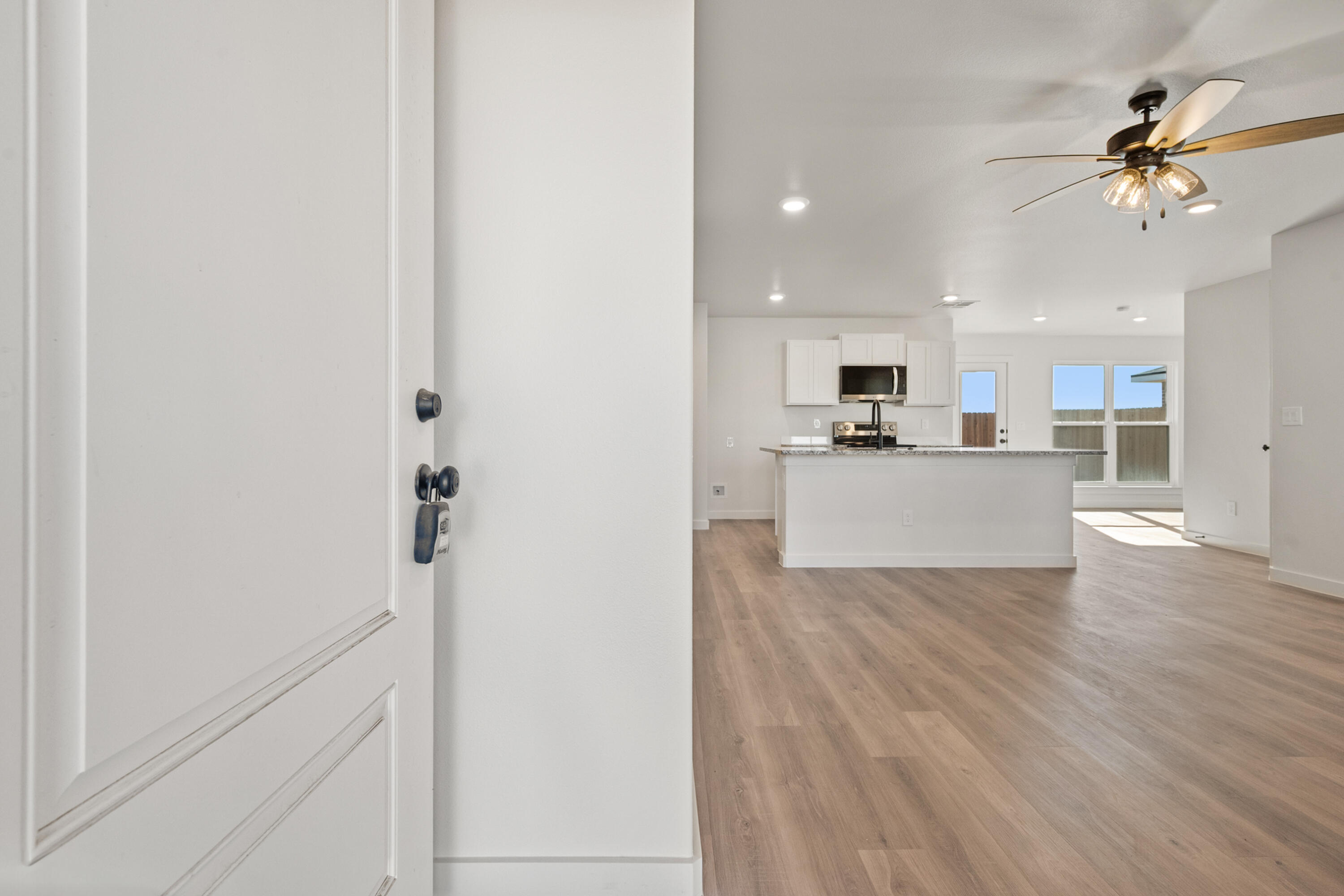 8305 24th Street Lubbock, TX 79407 - Photo 3 of 25 a view of a kitchen with wooden floor and a sink