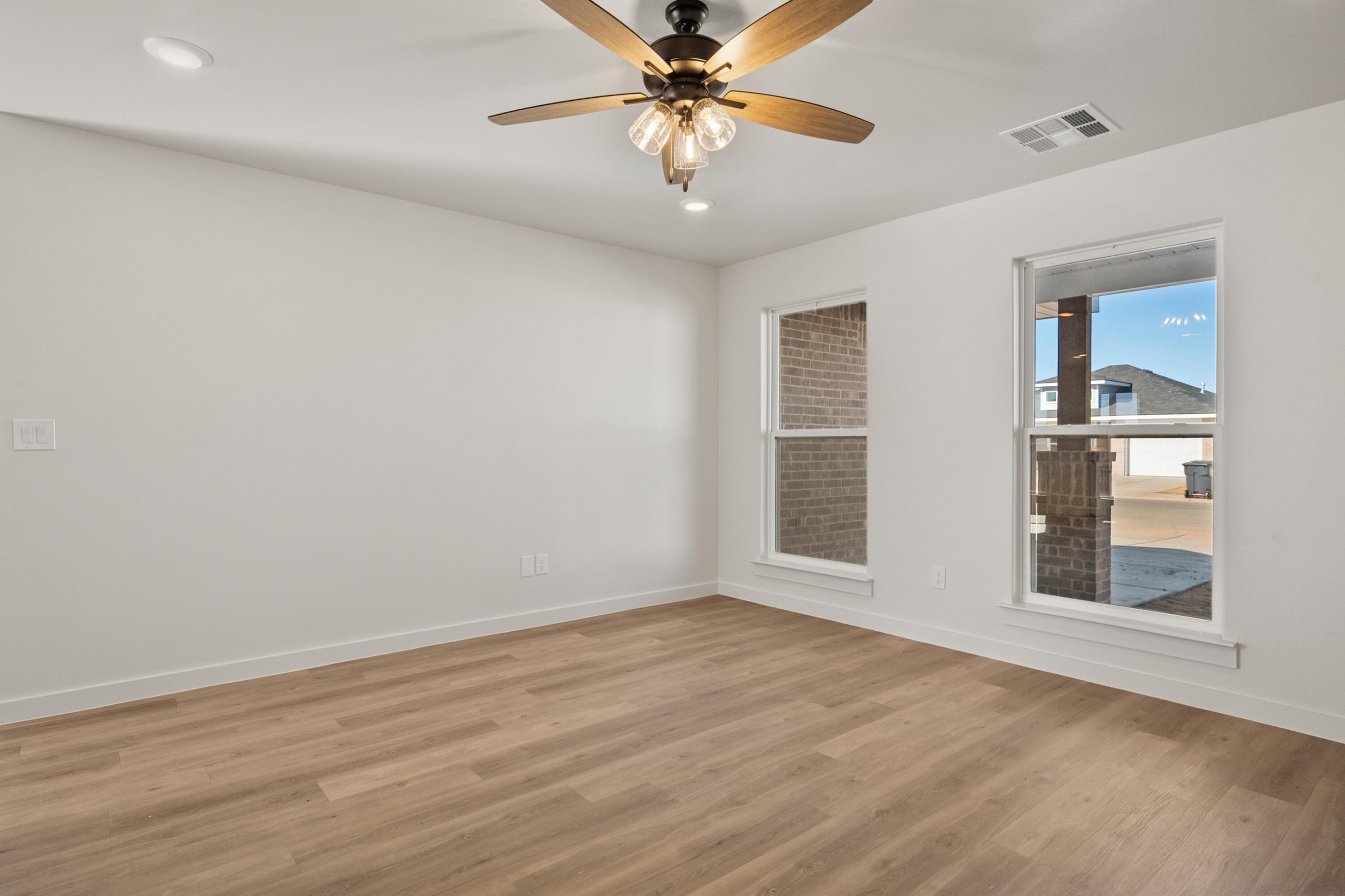 8305 24th Street Lubbock, TX 79407 - Photo 8 of 25 wooden floor in an empty room with a window