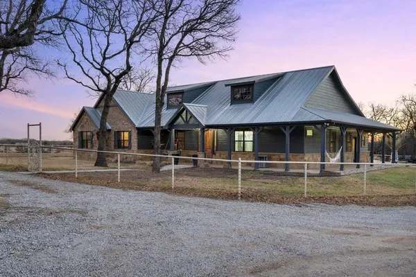 a house that has a tree in front of it