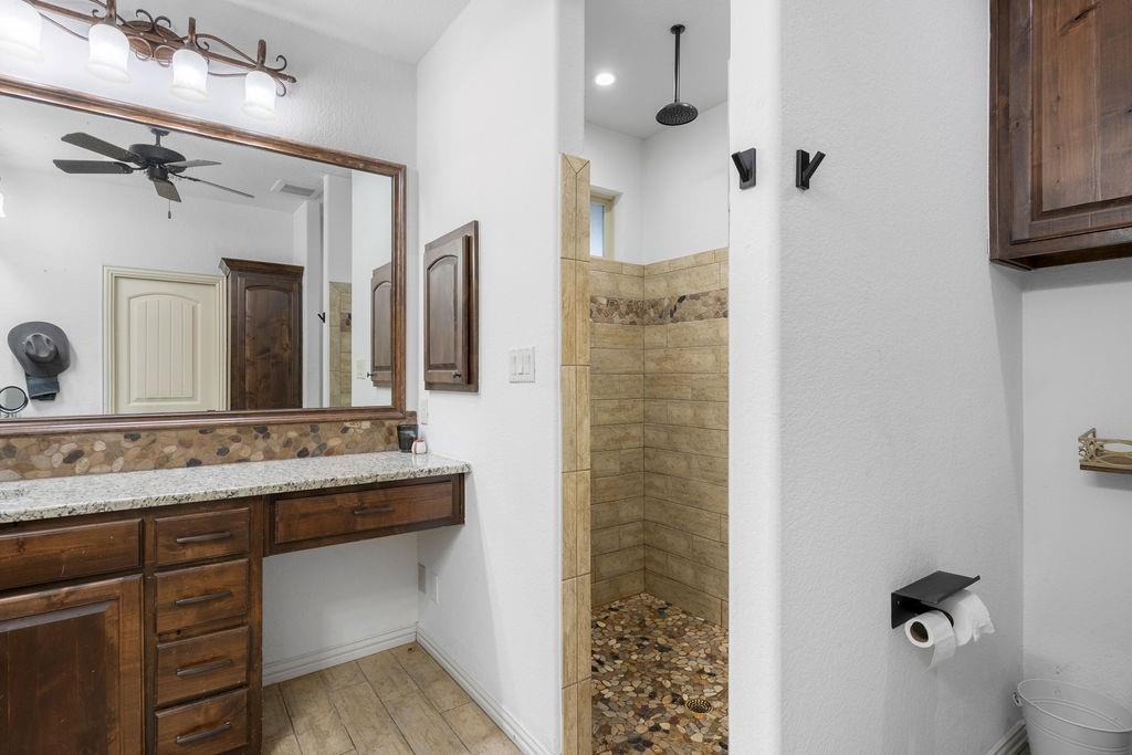 4069 Farm To Market Road 730 North Decatur, TX 76234 - Photo 13 of 33 a bathroom with a granite countertop sink a mirror and shower
