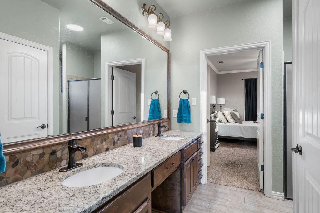 4069 Farm To Market Road 730 North Decatur, TX 76234 - Photo 19 of 33 a en suite bathroom with a granite countertop double vanity sink and a mirror