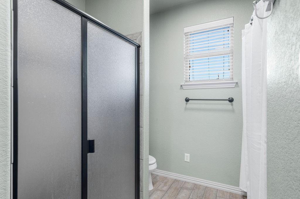4069 Farm To Market Road 730 North Decatur, TX 76234 - Photo 20 of 33 a bathroom with a glass shower door