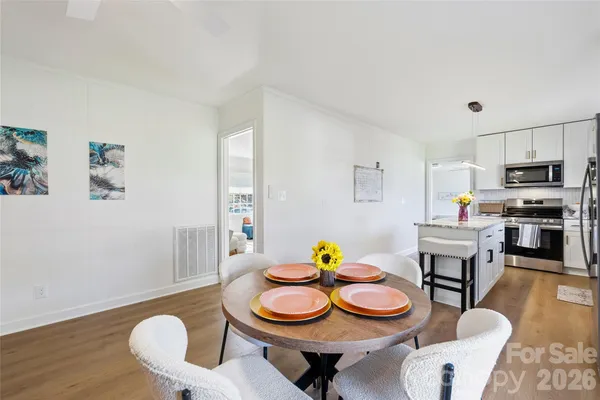 a view of a dining room with furniture and wooden floor