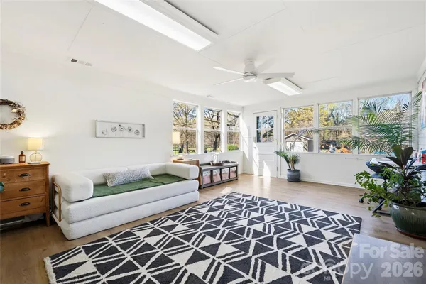 a living room with furniture and flowers