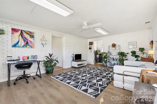 a bedroom with furniture and a rug