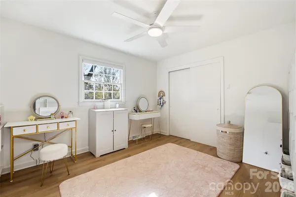 a spacious bedroom with a bed and a desk