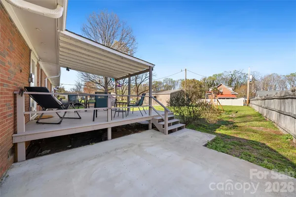 a view of a patio with a table and chairs