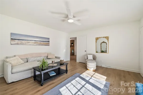 a living room with furniture and wooden floor
