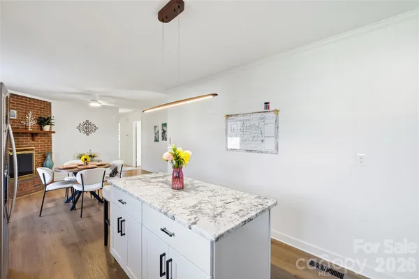 a kitchen with a sink cabinets and wooden floor