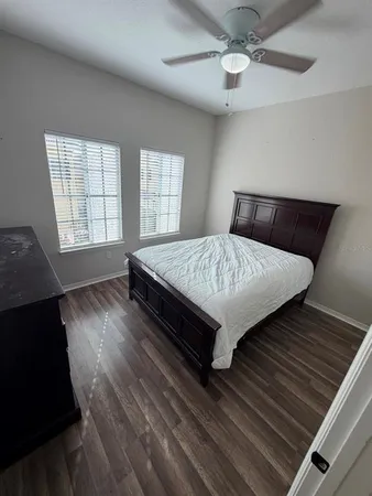 a bed sitting in a bedroom next to a window