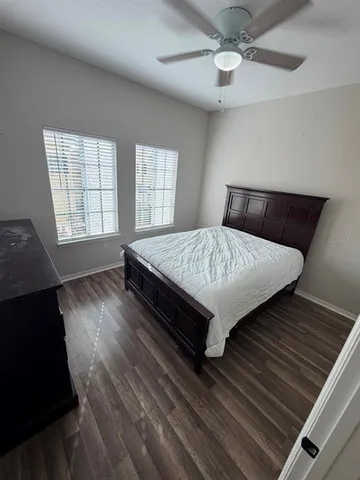 a bed sitting in a bedroom next to a window