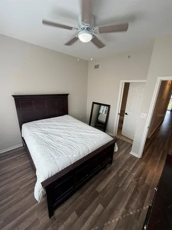 a bed sitting in a bedroom with a tv