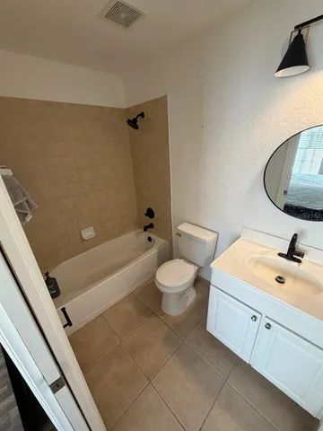 a bathroom with a toilet a sink and bathtub
