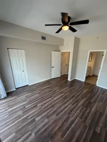 a view of empty room with wooden floor