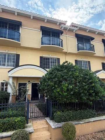 a front view of a house with plants
