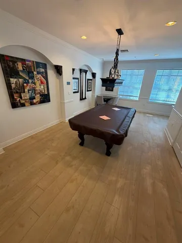 a room with pool table and wall paintings