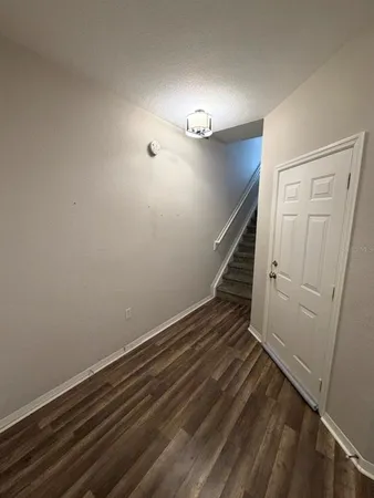 a view of entryway with stairs and wooden floor