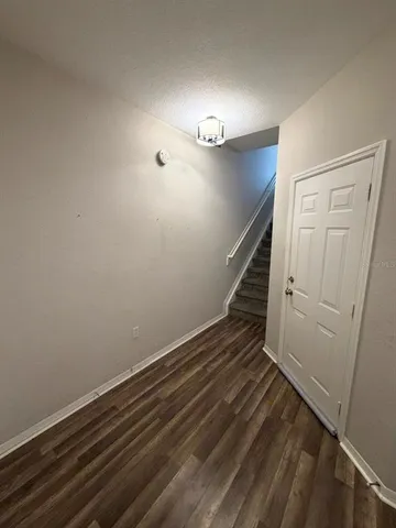 a view of entryway with stairs and wooden floor