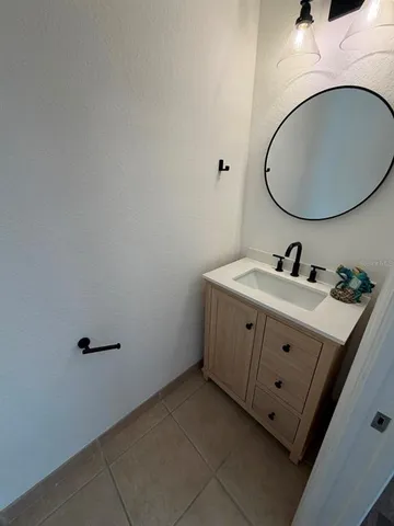 a bathroom with a sink mirror and vanity