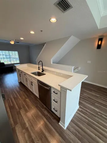 a kitchen with a sink and cabinets