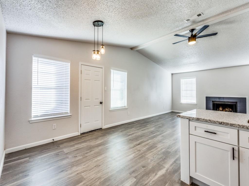 7457 Tiffany Meadows Lane Fort Worth, TX 76140 - Photo 11 of 18 a view of an empty room with a window and wooden floor