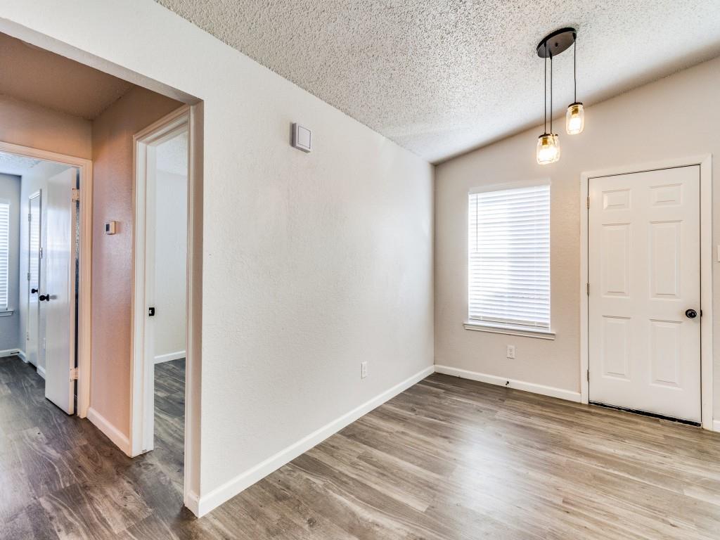 7457 Tiffany Meadows Lane Fort Worth, TX 76140 - Photo 14 of 18 a view of empty room with wooden floor and fan