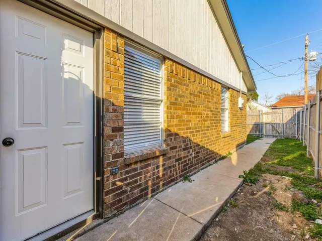 a view of a backyard with a large tree