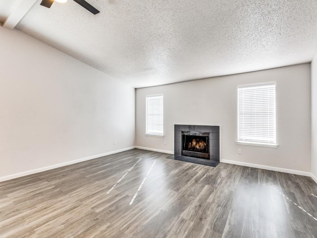 7457 Tiffany Meadows Lane Fort Worth, TX 76140 - Photo 4 of 18 an empty room with windows a fireplace