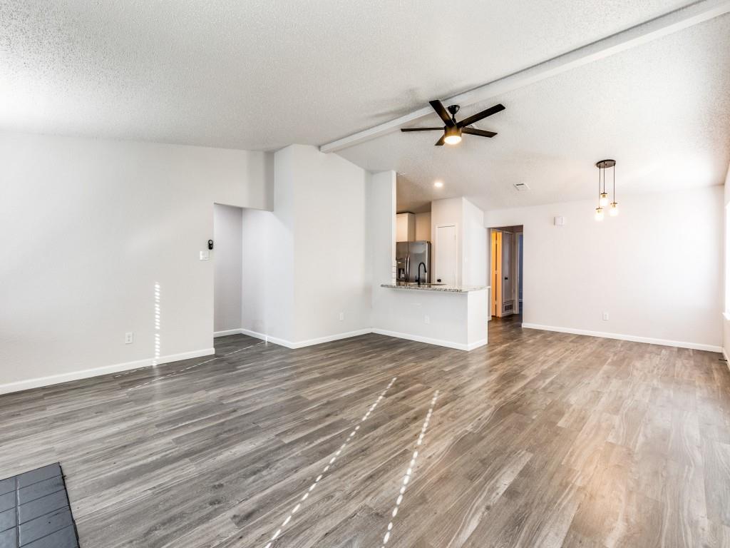 7457 Tiffany Meadows Lane Fort Worth, TX 76140 - Photo 7 of 18 wooden floor in an empty room with a window